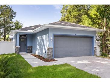 Charming one-story home with attached garage and blue exterior at 1203 W 16Th St, Sanford, FL 32771