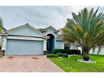 Charming single-story home with a two-car garage and well-manicured front yard at 1474 Lake Side Ave, Davenport, FL 33837
