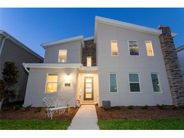 Charming two-story home with modern architectural details, beautiful stone accents and a welcoming walkway at 2836 Simile St, Kissimmee, FL 34746