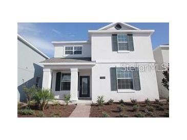 Charming two-story home with symmetrical design, dark shutters, and inviting entrance at 11834 Epic Ave, Orlando, FL 32832