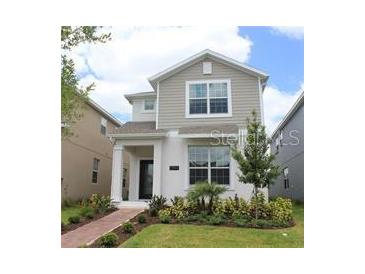 Charming two-story home featuring neutral colors, a landscaped yard and a welcoming walkway at 11941 Sonnet Ave, Orlando, FL 32832