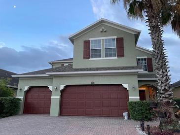 Charming two-story home with a three car garage and well-maintained landscaping at 12610 Sawgrass Oak St, Orlando, FL 32824