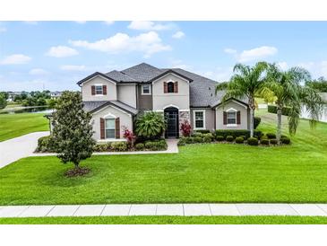 Beautiful two-story home featuring manicured landscaping and a large front yard at 2260 Grayling St, Orlando, FL 32820