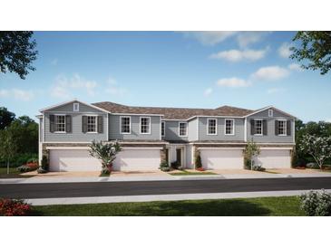 Charming townhome showcasing modern architecture, a private garage, and beautifully landscaped surroundings at 354 Thompson Village Ave, Apopka, FL 32703