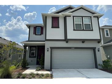 Charming two-story home boasts a two-car garage, landscaped front yard, and a welcoming facade at 6268 Great Bear Dr, Lakeland, FL 33805