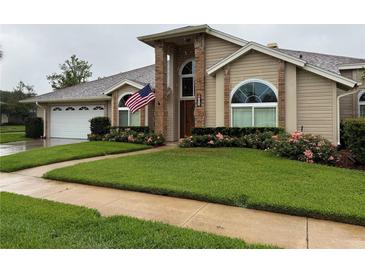 Charming single-Gathering home with manicured lawn, beautiful landscaping, and an American flag at 872 Silverwood Dr, Lake Mary, FL 32746