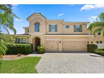 Stunning two-story home featuring a tile roof, three-car garage, and beautifully paved driveway at 1501 Prairie Oaks Dr, St Cloud, FL 34771
