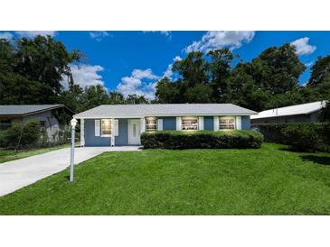 Charming single-story home featuring a lush green lawn, neat landscaping, and a freshly painted exterior at 1507 Sw 4Th St, Ocala, FL 34471