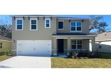 Charming two-story home with a well-maintained lawn, attached two car garage, and welcoming front porch at 776 Mocking Jay Ln, St Cloud, FL 34771