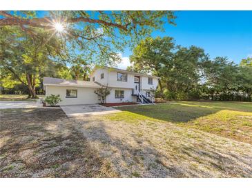 Charming two-story home with lush landscaping and a sun-drenched front yard at 2550 Barren Oak Ct, Deland, FL 32720