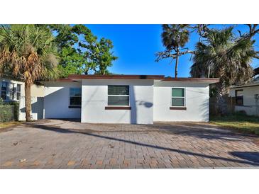 Cozy single-story home featuring a brick driveway and mature landscaping at 326 Hobart Ave, Daytona Beach, FL 32114