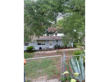 Charming single-story home with mature trees and a fenced yard for added privacy and curb appeal at 3600 Ne 22Nd Ct, Ocala, FL 34479