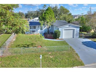 Charming single-story home with a fenced yard, freshly painted exterior, and well-manicured landscaping at 642 Carver Dr, Lake Wales, FL 33853