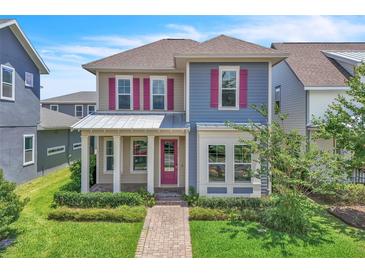 Charming two-story home featuring pink shutters, a covered front porch, and manicured landscaping at 8226 Nemours Pkwy, Orlando, FL 32827