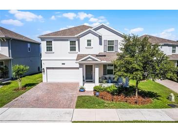 Charming home with a brick driveway and front porch seating at 1123 Dora Parc Ln, Mount Dora, FL 32757