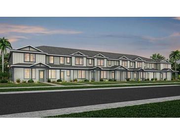 New construction townhomes offer charming exteriors with sidewalks and landscaping at 11352 Blue Bay Dr, Orlando, FL 32832
