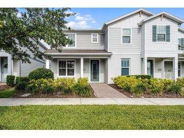 Charming two-story home featuring a well-manicured lawn and inviting front porch at 14538 Orchid Island Dr, Orlando, FL 32827