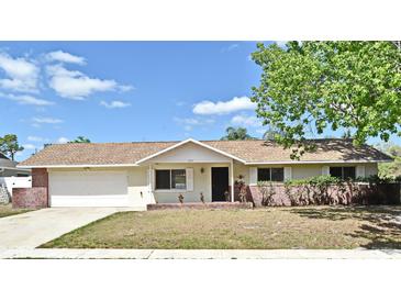 Charming single-story home with a well-maintained lawn and an attached two-car garage at 1515 Pelican St, Longwood, FL 32750