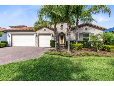Beautiful exterior view of home with landscaped front yard and palm trees at 16696 Otterchase Ln, Winter Garden, FL 34787