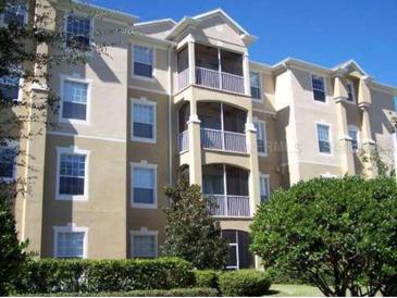 Beige multistory building with screened in balconies and well maintained landscaping at 2785 Almaton Loop # 204, Kissimmee, FL 34747