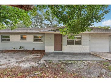 Charming single-story home with a light gray exterior, front yard, and attached garage at 384 Zinnia Dr, Casselberry, FL 32707