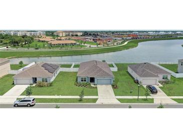 An aerial view showcasing the home's location near a pond and walking trails at 392 Citrine Loop, Kissimmee, FL 34758