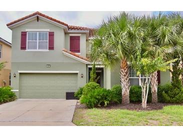 Charming two-story home featuring a well-manicured lawn and beautiful landscaping, offering great curb appeal at 5273 Oakbourne Ave, Davenport, FL 33837