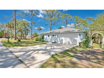 Charming single-story home with well-manicured lawn, inviting curb appeal, and attached two-car garage at 5505 W Magnolia Ave, Port Orange, FL 32127