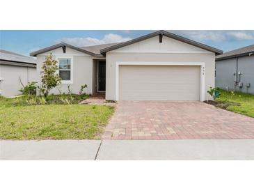 Charming single-Gathering home featuring a brick driveway and well-maintained front yard at 856 Teton St, Haines City, FL 33844