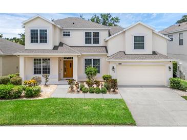 Charming two-story home featuring a well-manicured lawn and inviting front entrance at 10125 Sandy Marsh Ln, Orlando, FL 32832