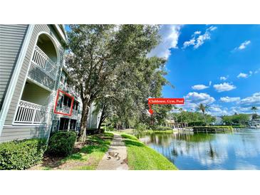 Scenic view of the condo building, lake, and community amenities like the clubhouse, gym, and pool at 2314 Midtown Ter # 1126, Orlando, FL 32839