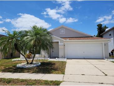 Charming one-story home with a well-manicured lawn and attached two-car garage at 3156 Natoma Way, Orlando, FL 32825