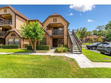 Charming condo building with a well-manicured lawn and lush landscaping at 325 Forestway Cir # 104, Altamonte Springs, FL 32701
