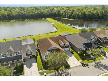 Aerial view of home with lake view, showcasing lush greenery and water at 4608 Atwood Dr, Orlando, FL 32828