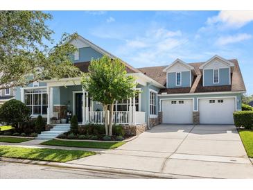 Charming two-story home featuring a three-car garage and inviting front porch at 4608 Atwood Dr, Orlando, FL 32828