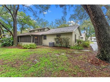Charming single-story home with a screened porch and lush landscaping at 4772 Lake Ridge Rd # 66, Orlando, FL 32808