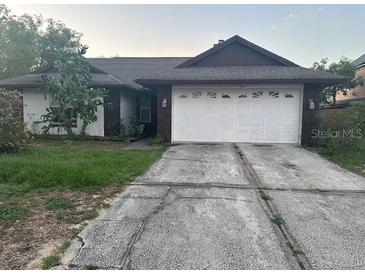 Charming single-story home featuring an attached two-car garage at 7625 Jarvis Ct, Orlando, FL 32818
