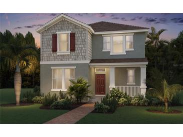 Charming two-story home with a combination of siding and shingles and a well-manicured lawn and landscaping at 11182 Hollow Bay Dr, Winter Garden, FL 34787