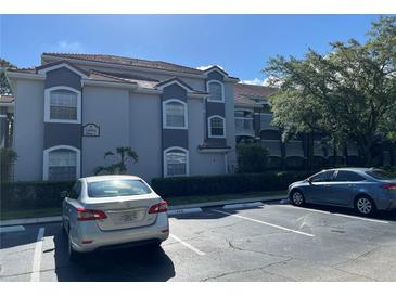 Exterior view of the building with clean curb appeal and ample parking spots at 14001 Fairway Island Dr # 525, Orlando, FL 32837