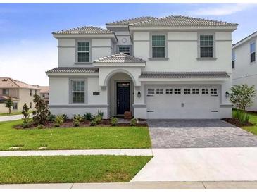 Charming two-story home with manicured lawn and a two-car garage at 1575 Plunker Dr, Davenport, FL 33896