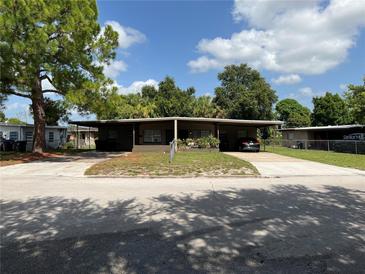 Inviting single-story home with a covered carport and well-kept lawn at 2506 Perrine Pl, Orlando, FL 32808