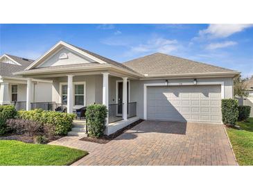 Charming single-story home featuring a covered front porch and a two-car garage at 338 Wooded Vine Dr, Winter Springs, FL 32708