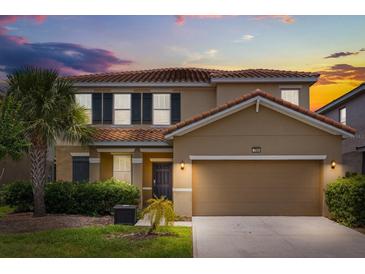 Charming two-story home with a well-maintained lawn and a two-car garage at 7041 Oakwood St, Davenport, FL 33837