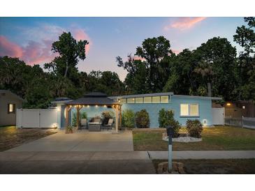 Charming single-story home with a covered outdoor seating area and well-maintained landscaping at 793 Greenway Pl, Daytona Beach, FL 32114