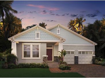 Charming single-story home featuring craftsman-style architecture and a two-car garage in a lush, tropical landscape at 11003 Hollow Bay Dr, Winter Garden, FL 34787