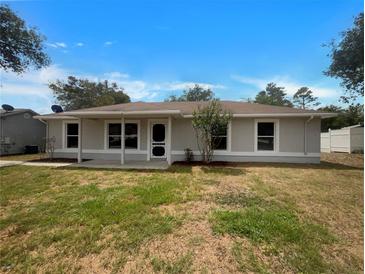 Charming single story home with well-maintained lawn, neutral color, and inviting front entrance at 3090 Yorkshire Dr, Deltona, FL 32738