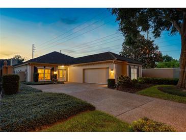 Charming single-story home with a two-car garage, well-manicured landscaping, and a private driveway at 5973 Chesapeake Park # 58, Orlando, FL 32819