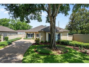 Charming single story home featuring mature trees, lush landscaping, and a private courtyard at 5973 Chesapeake Park # 58, Orlando, FL 32819