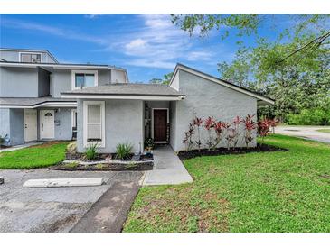 Charming townhome featuring a landscaped front yard and neutral gray exterior at 701 Saint Michael Ln, Altamonte Springs, FL 32714