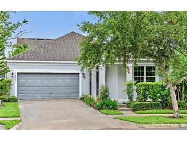 Charming single-Gathering home with gray exterior, attached garage, and landscaped front yard at 12691 Calderdale Ave, Windermere, FL 34786
